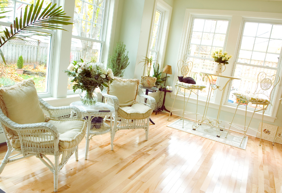 a light and airy toned sunroom with light flooring